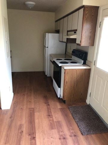 Orwigsburg apartment for rent - A kitchen with a white fridge and black stove top.