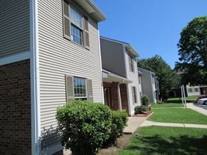 Orwigsburg apartment for rent - A building with a grey siding and a red brick pillar.