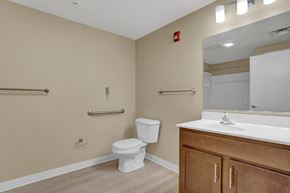 Harrisburg apartment for rent - A bathroom with a toilet, sink, and mirror.