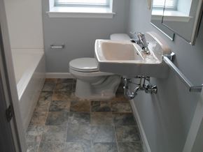 Coatesville apartment for rent - A white toilet is in a bathroom with a sink and a window.