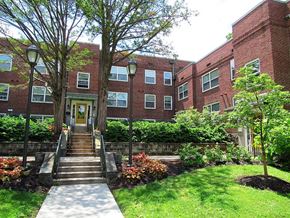 Coatesville apartment for rent - A red brick building with a tree in front of it.