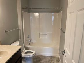 Mechanicsburg apartment for rent - A white bathroom with a toilet, sink, and bathtub.