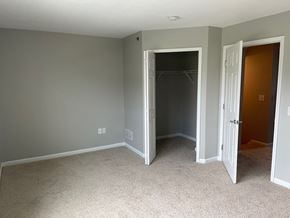 Mechanicsburg apartment for rent - A room with a carpeted floor and two open doors.