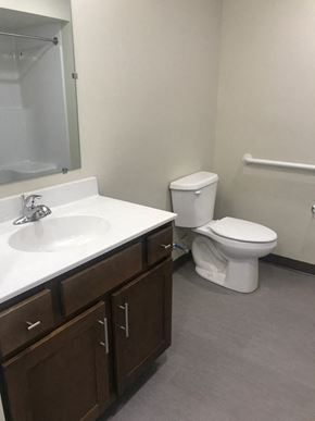 Pittston apartment for rent - A white toilet sits next to a sink in a bathroom.