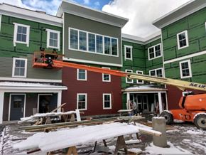 Pittston apartment for rent - A red house is being painted green.