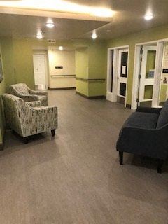 Pittston apartment for rent - A room with a grey carpet and two chairs.