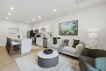 Sterling Heights apartment for rent - A modern living room with a grey coffee table in the center.