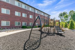 Chesterfield apartment for rent - A playground with a slide and a building in the background.