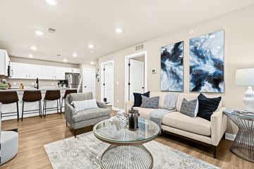 Sterling Heights apartment for rent - A modern living room with a glass coffee table and a grey sofa.