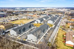 Sterling Heights apartment for rent - A large parking lot with several buildings in the background.