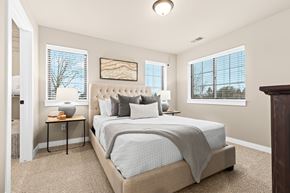 Sterling Heights apartment for rent - A bedroom with a large bed and a painting on the wall.