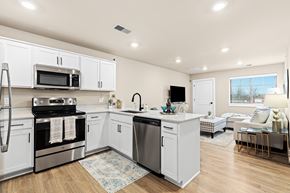 Sterling Heights apartment for rent - A modern kitchen with white cabinets and stainless steel appliances.