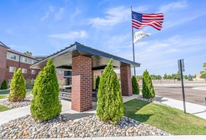 Chesterfield apartment for rent - A patio building with an American flag on top of it.