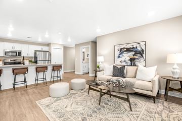 Chesterfield apartment for rent - A modern living room with a bar area and a rug on the floor.