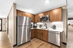 Sterling Heights apartment for rent - a kitchen with wooden cabinets and stainless steel appliances