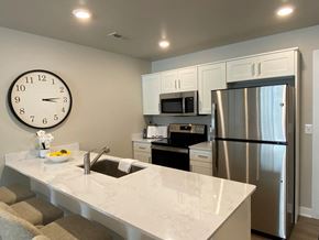 Shelby Township apartment for rent - a kitchen with a large quartz counter top and a stainless steel refrigerator