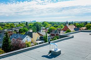 Calgary apartment for rent - A rooftop view of a residential area with houses and trees.