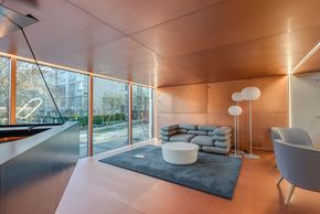 Vancouver condo for rent - A modern living room with a large window and a grey sofa.