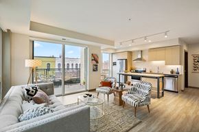 Minneapolis apartment for rent - a living room with a couch and chairs and a kitchen with