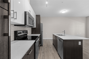Calgary apartment for rent - a renovated kitchen with white counter tops and stainless steel appliances