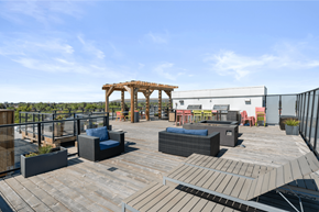 Calgary apartment for rent - a rooftop patio with wooden furniture and a wooden gazebo