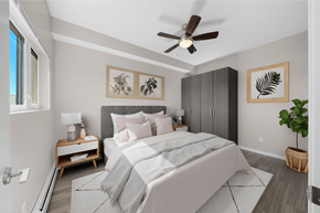 Calgary apartment for rent - a bedroom with a large bed and a ceiling fan