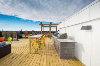 Spectacular rooftop patio with bbq stations, firepits, stylish furniture