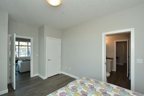 Airdrie apartment for rent - A bedroom with a bed and a window.