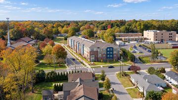 Charlotte apartment for rent - A view of a residential area with houses and a large building in the background.