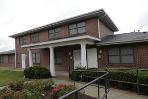 Charlotte apartment for rent - A red brick house with a white door and windows.
