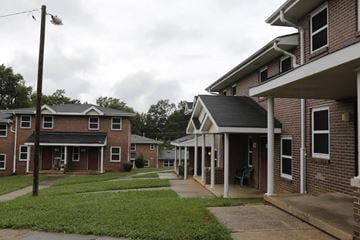 Charlotte apartment for rent - A row of houses with a grassy area in between.