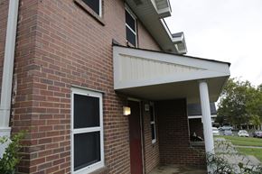 Charlotte apartment for rent - A red brick house with a white door and window.