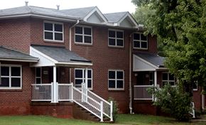 Charlotte apartment for rent - A red brick house with a white porch.