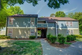 Charlotte apartment for rent - A two-story house with a brown roof and a garage door.