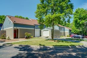 Charlotte apartment for rent - A house with a red door and a tree in front of it.