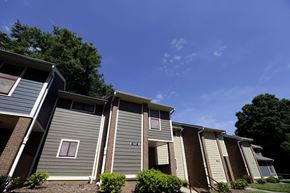 Charlotte apartment for rent - A row of houses with the first one having a red window.