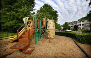 Charlotte apartment for rent - A playground with a slide, climbing wall, and a tunnel.