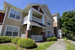 Charlotte apartment for rent - A two-story apartment building with a red and beige exterior.