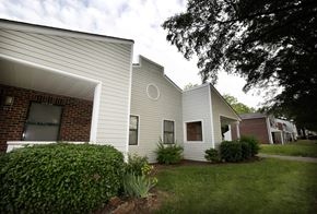 Charlotte apartment for rent - A house with a white siding and a brick chimney.