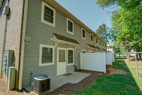 Charlotte apartment for rent - A row of houses with a green lawn in front.