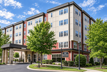 Charlotte apartment for rent - A multi-story hotel with a red and white sign in front.