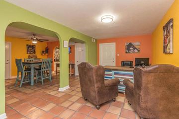 Plano apartment for rent - A living room with a brown chair and a brown couch.