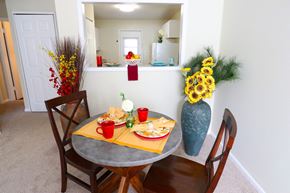 Smyrna apartment for rent - a dining area with a table and chairs and a vase of flowers