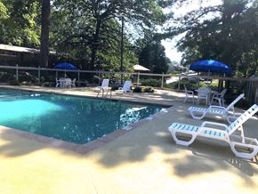 Smyrna apartment for rent - a swimming pool with chairs and umbrellas around it