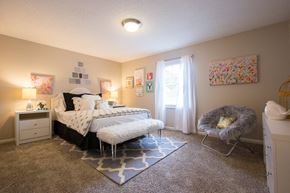 Atlanta apartment for rent - a bedroom with a bed and a chair and a window