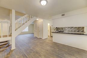 North Charleston apartment for rent - A spacious room with wooden flooring and a staircase on the left side.