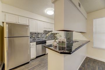 North Charleston apartment for rent - A kitchen with a stainless steel refrigerator and a granite countertop.