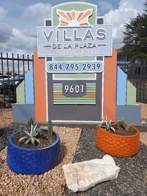 Austin apartment for rent - A sign for Villas De La Plaza Apartments with a phone number and a zip code.