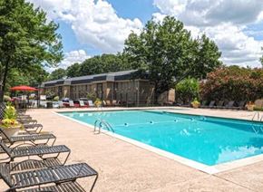 Atlanta apartment for rent - a swimming pool with benches and chairs around it