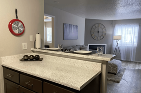 Austin apartment for rent - A kitchen with a white countertop and a clock hanging on the wall.